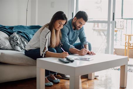 couple signing documents at home
