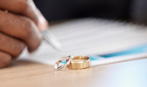 Divorce, rings and signature on paperwork for a lawyer